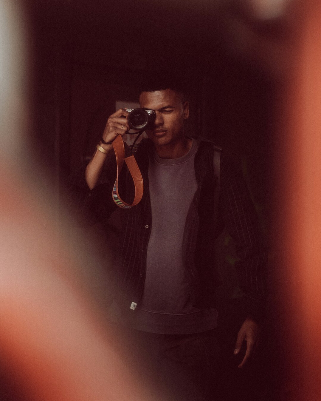 Portuguese man in his thirties holding a camera, professional portrait