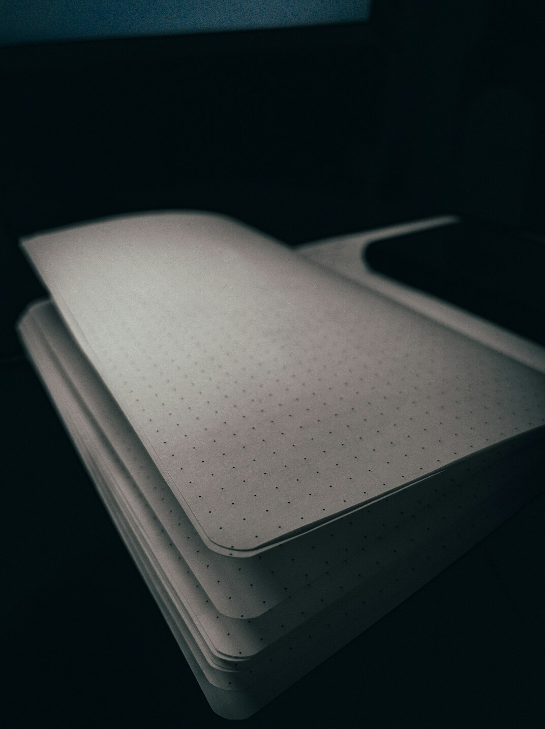 Stacked confidential paper documents and a folder on a desk