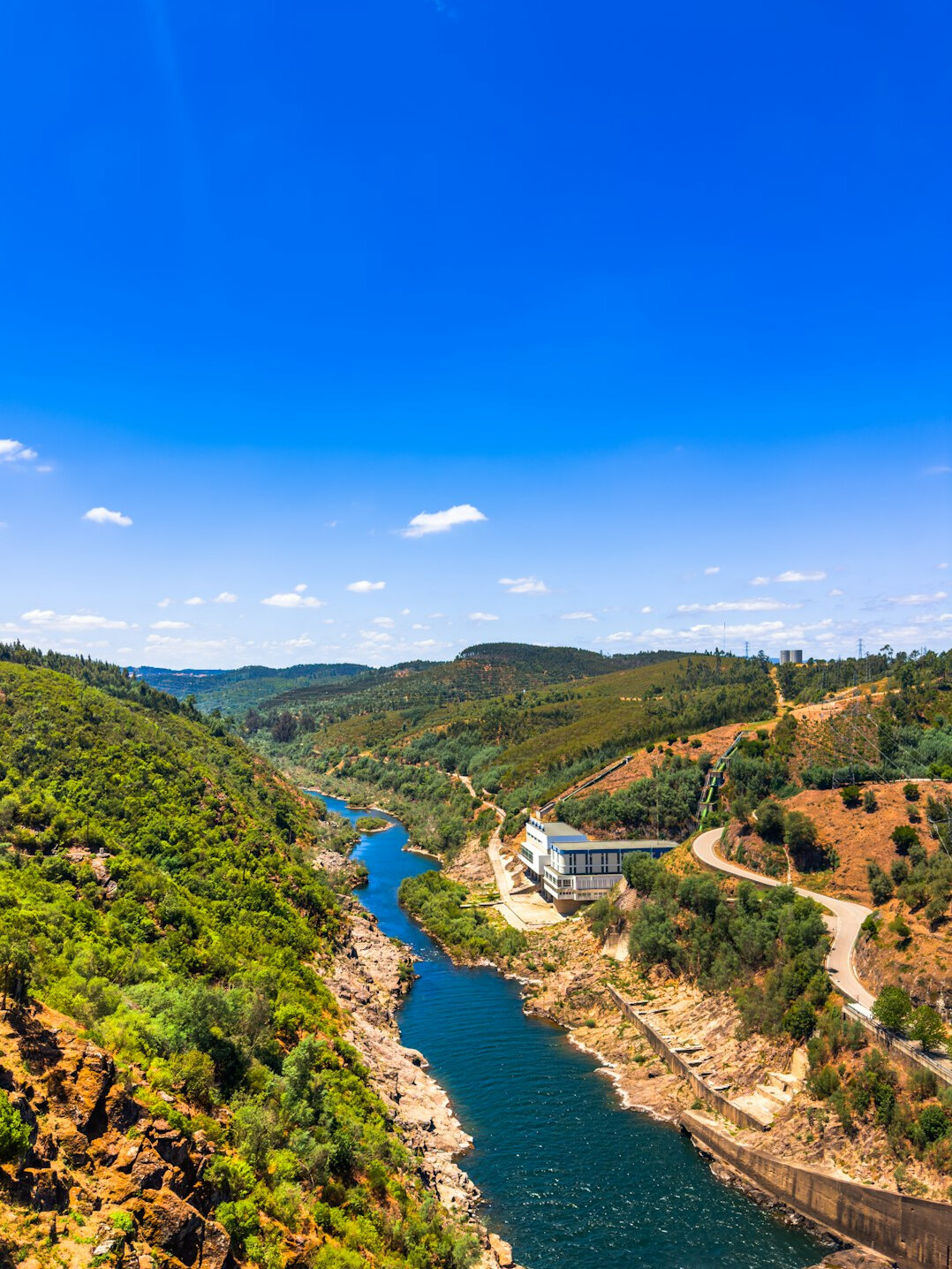 Aerial view of a winding river through a green valley in Portugal